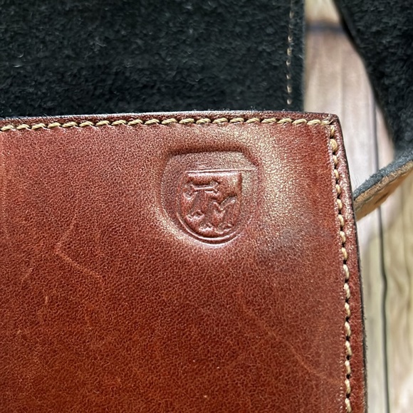 brown leather and features the gold-toned horsebit hardware.  B36 - Picture 7 of 9